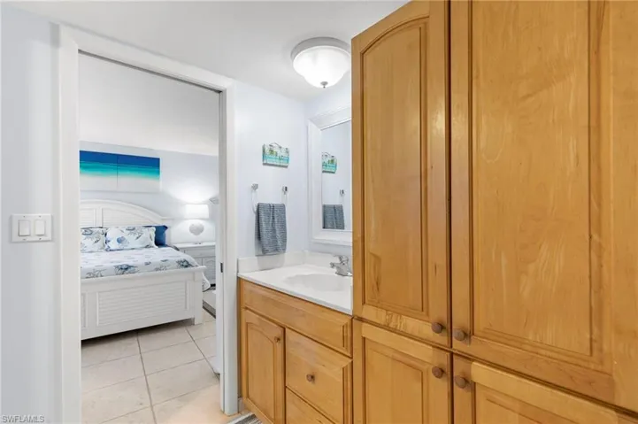 Ensuite bathroom featuring vanity and light tile patterned floors