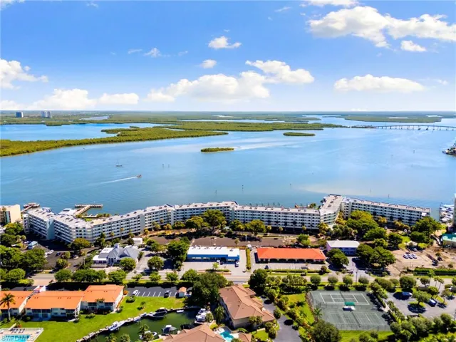 Bird's eye view of apartment complex and a nearby body of water