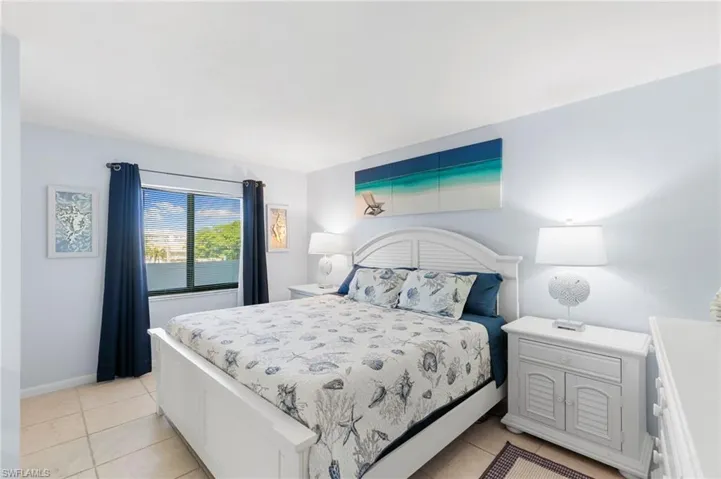 Bedroom featuring light tile patterned floors and baseboards