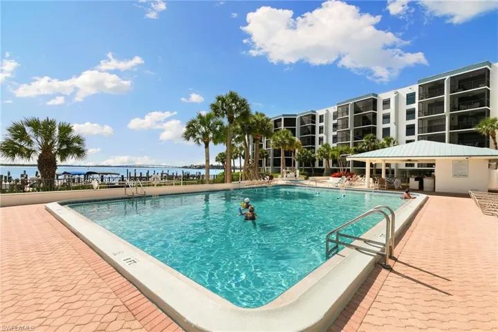 Community pool featuring a patio and a water view