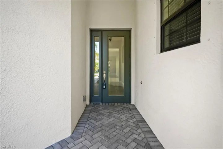 Entrance to property featuring stucco siding