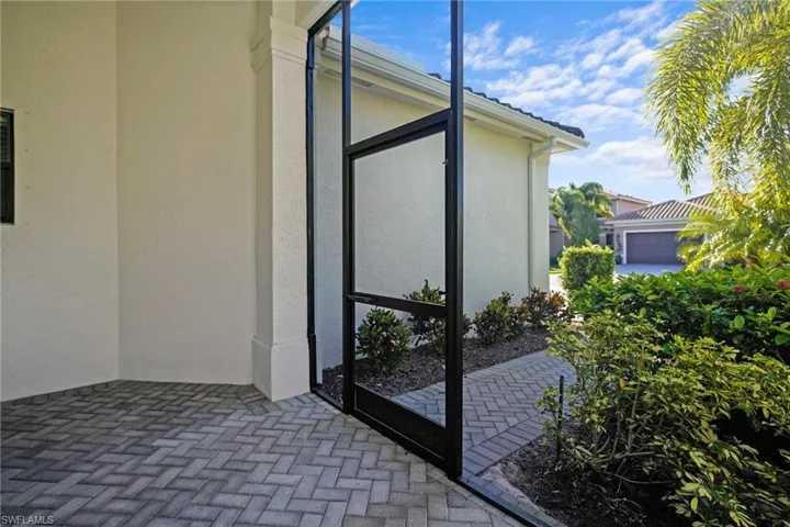 Entrance to property with a sunroom and stucco siding