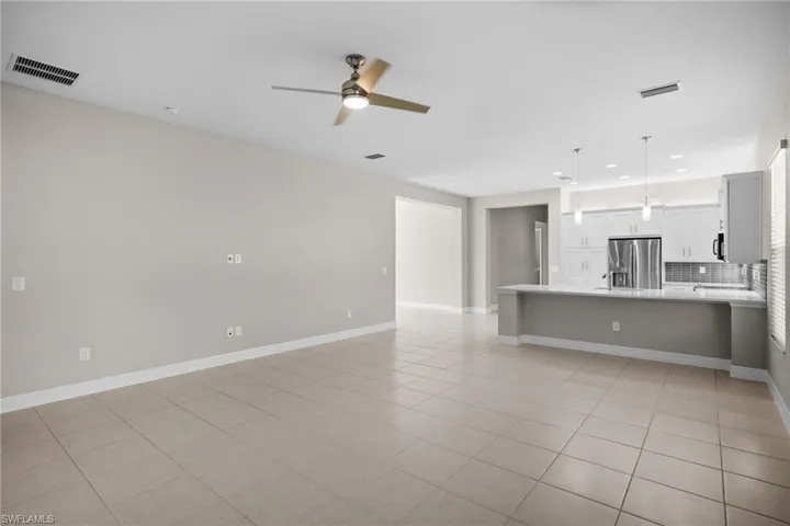 Unfurnished living room with light tile patterned floors, recessed lighting, and ceiling fan