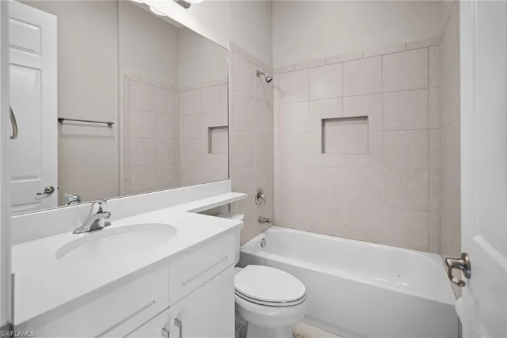 Bathroom featuring vanity and washtub / shower combination