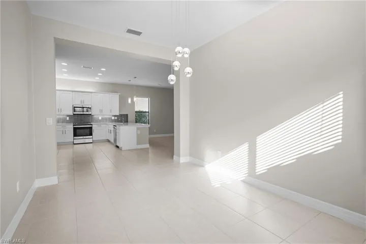 Unfurnished living room with light tile patterned floors and recessed lighting