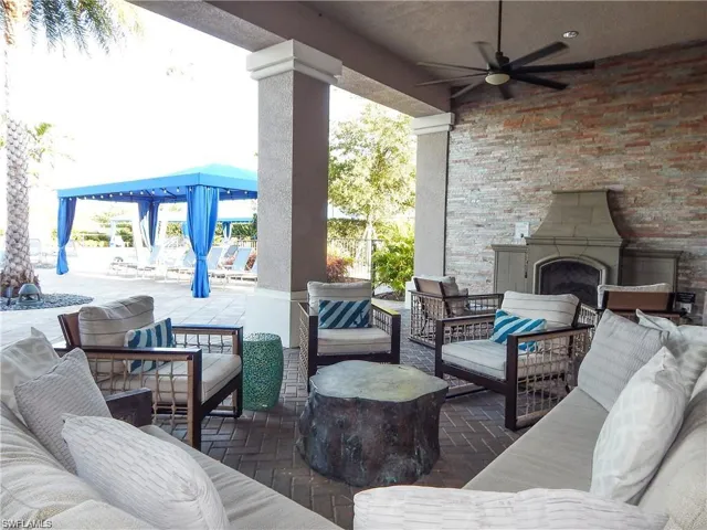 View of patio featuring an outdoor living space with a fireplace, a pergola, and a ceiling fan