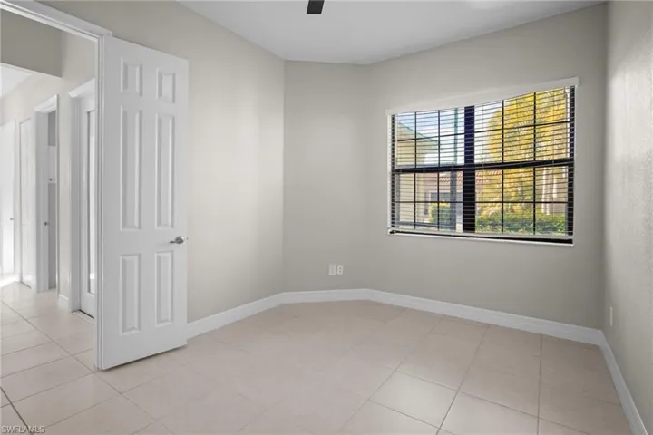 Spare room with light tile patterned floors and ceiling fan