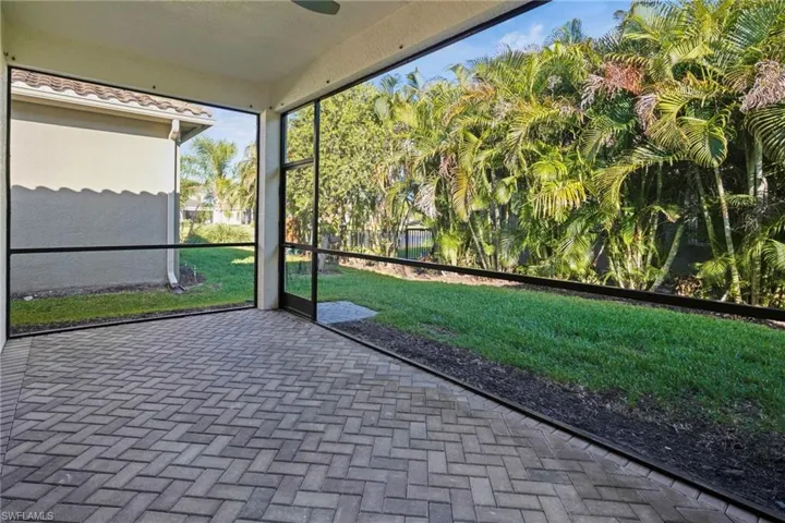 Unfurnished sunroom featuring ceiling fan
