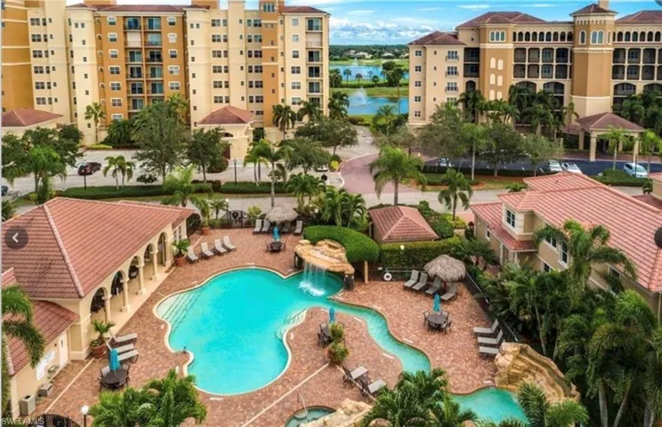 Community pool with a water view, a patio area, and a community hot tub