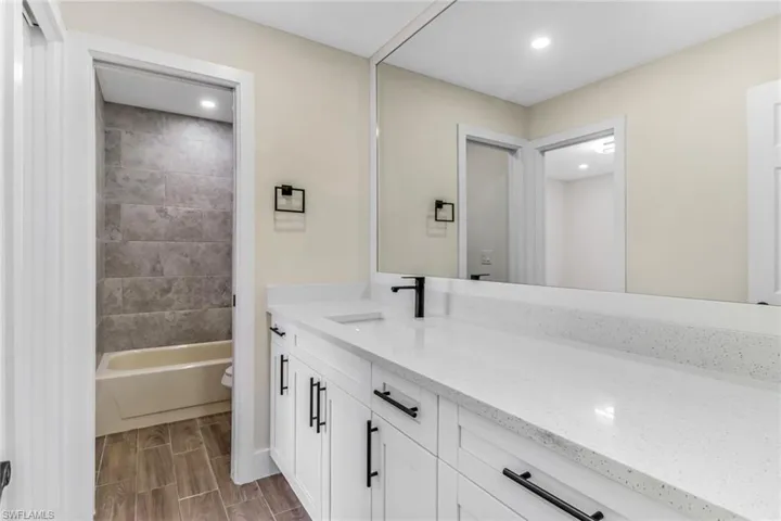 Primary Full bath featuring vanity, wood tiled floors, and recessed lighting