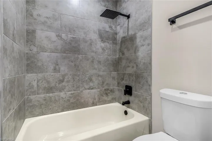 Full bath with shower / bath combination and toilet