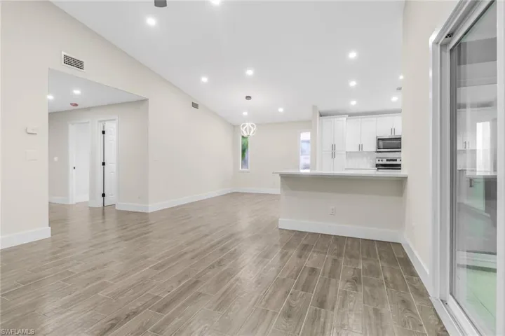 Unfurnished living room with recessed lighting and wood tiled floors