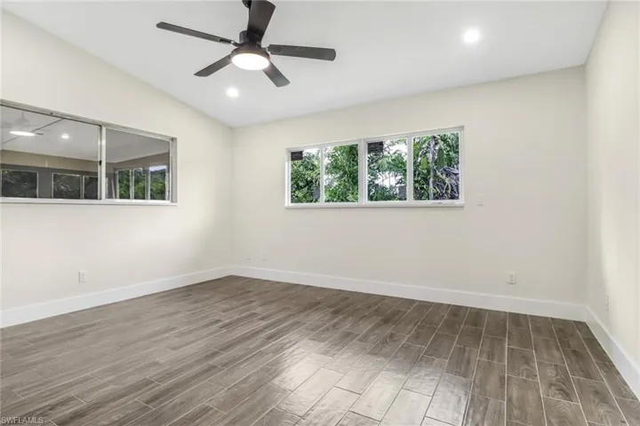 Spare room with wood tiled floors, recessed lighting, vaulted ceiling, and ceiling fan