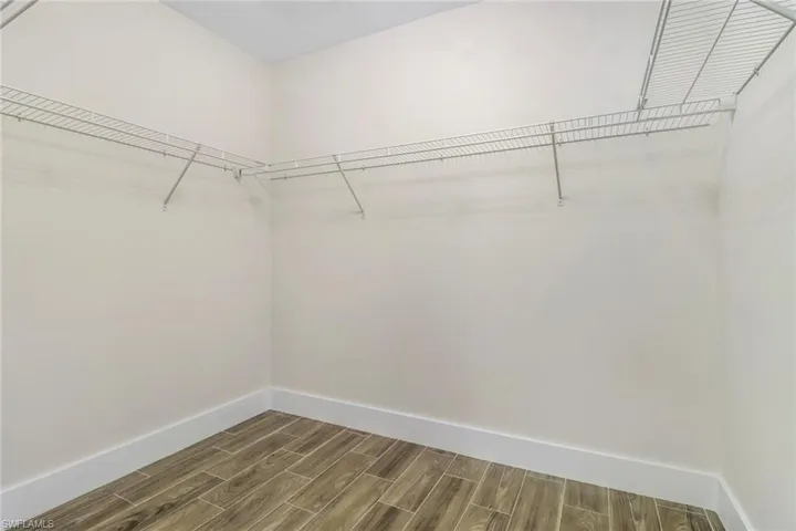 Spacious closet with wood tiled floors
