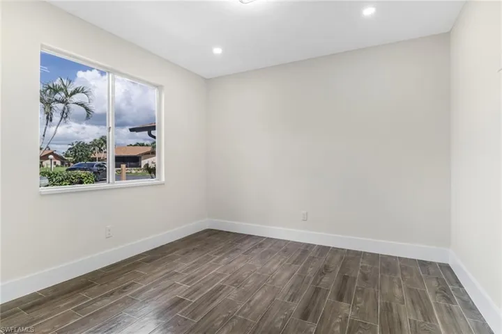 Empty room featuring wood finish floors and recessed lighting