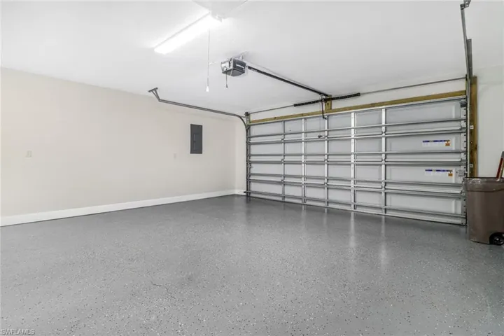 2 Stall Garage with electric panel and a garage door opener
