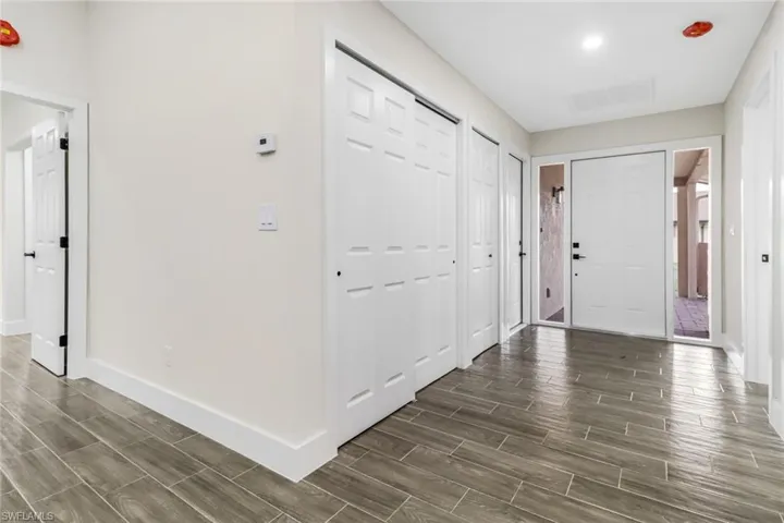 Foyer featuring wood style Tile floors and baseboards