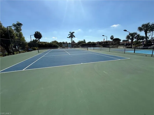 View of tennis court featuring community basketball court
