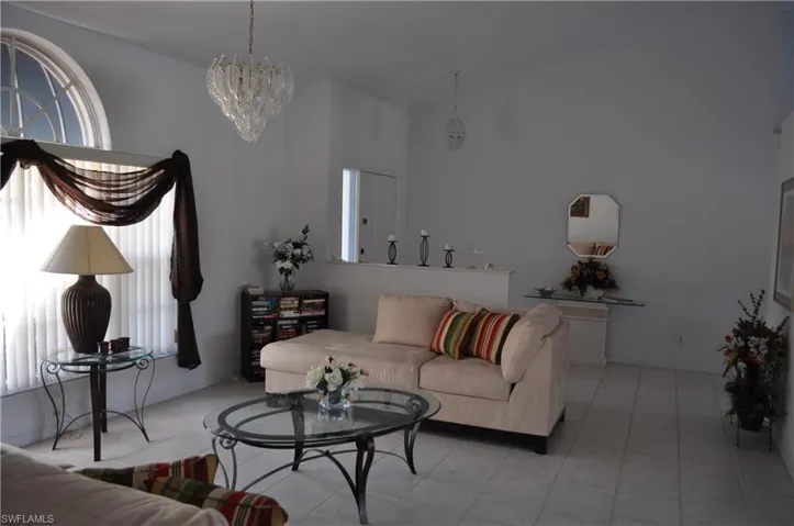 Tiled living area featuring a chandelier
