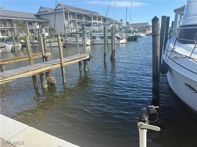 Private dock access featuring a wooden walkway and pilings