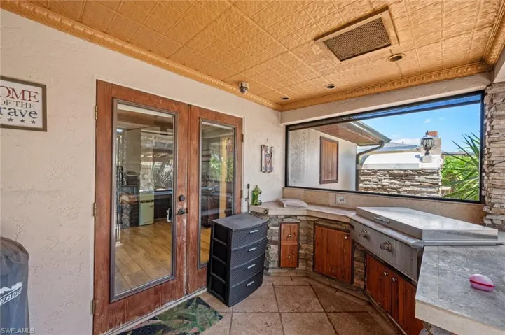View of patio with visible vents and area for grilling