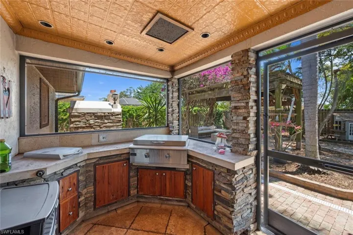 View of patio featuring a grill and an outdoor kitchen