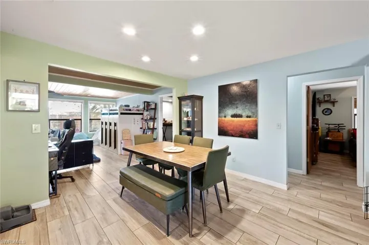 Dining room with baseboards, wood finish floors, and recessed lighting