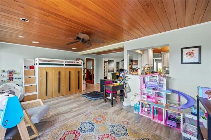 Recreation room featuring recessed lighting, light wood finished floors, wood ceiling, and ceiling fan