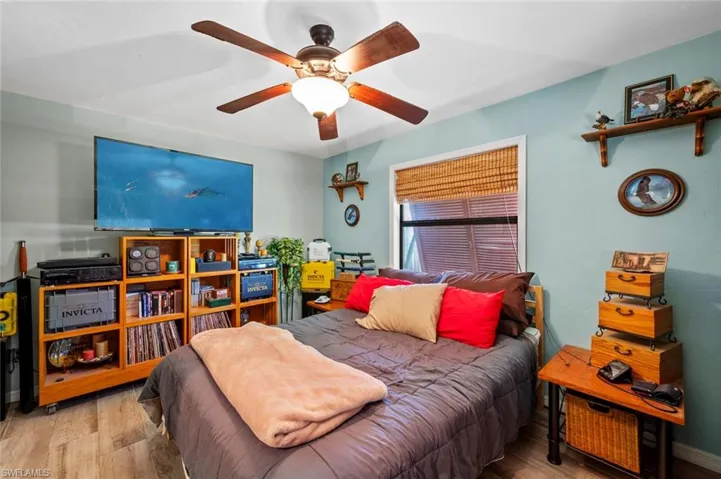 Bedroom featuring wood finished floors, ceiling fan, and baseboards