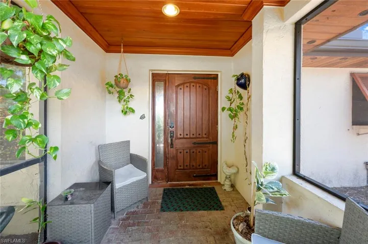 View of exterior entry featuring stucco siding