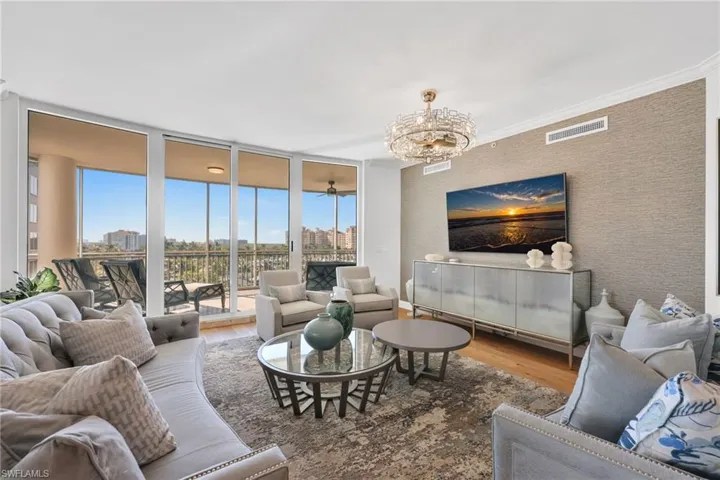 Living room with waterview and sliders to screened in lanai for effortless indoor/outdoor living