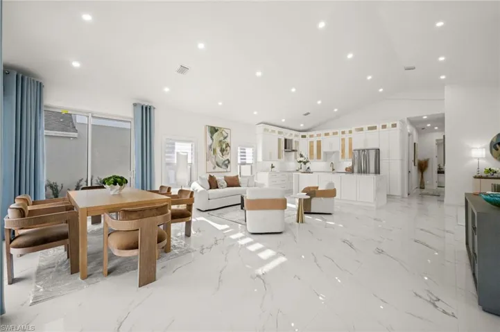 Living room with recessed lighting and lofted ceiling