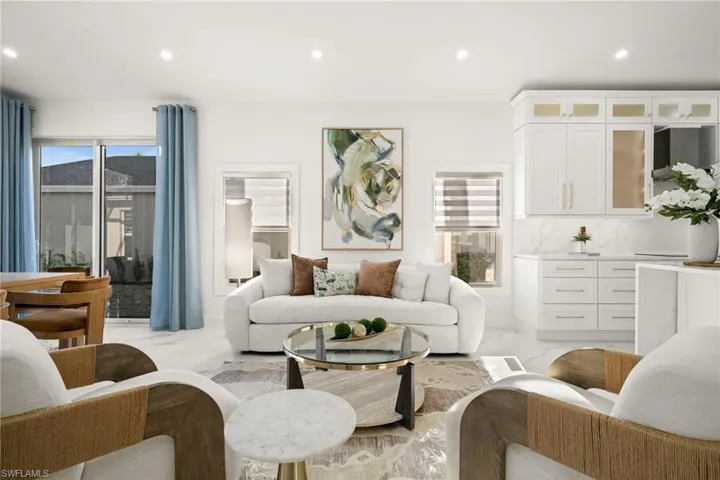 Living room with recessed lighting, plenty of natural light, and light marble finish flooring