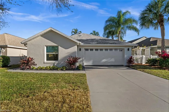 Single story home with stucco siding, an attached garage, and concrete driveway
