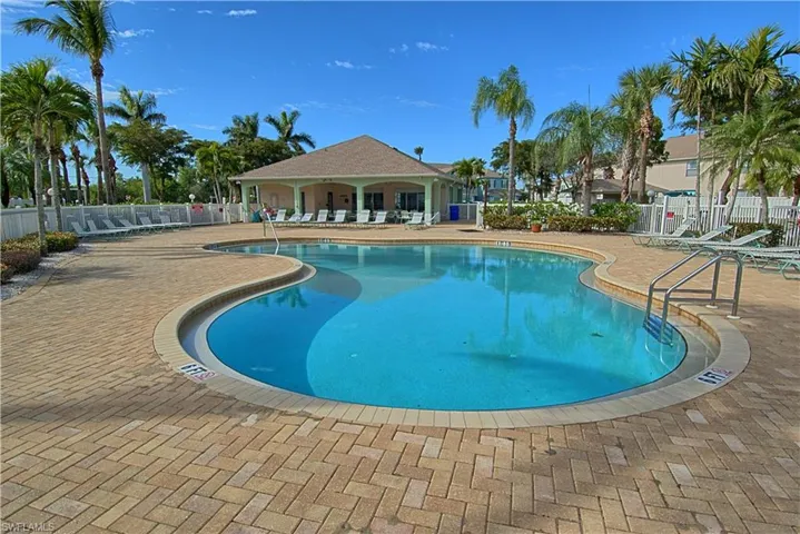 Community swimming pool with a patio area