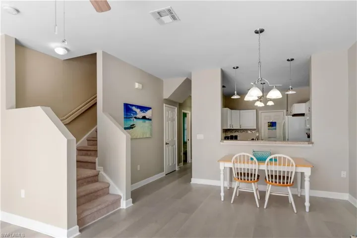 Stairwell with plush carpeting leading upstairs