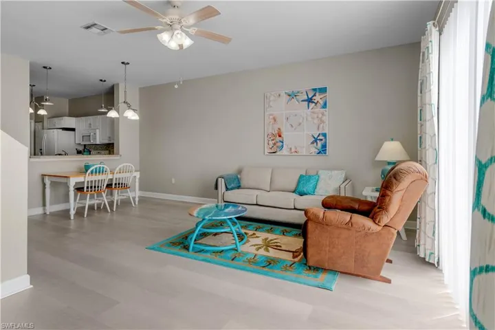 Living room featuring ceiling fan and light wood-style floors