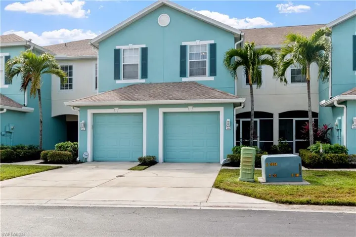 View of front of home with a your garage and screened entry