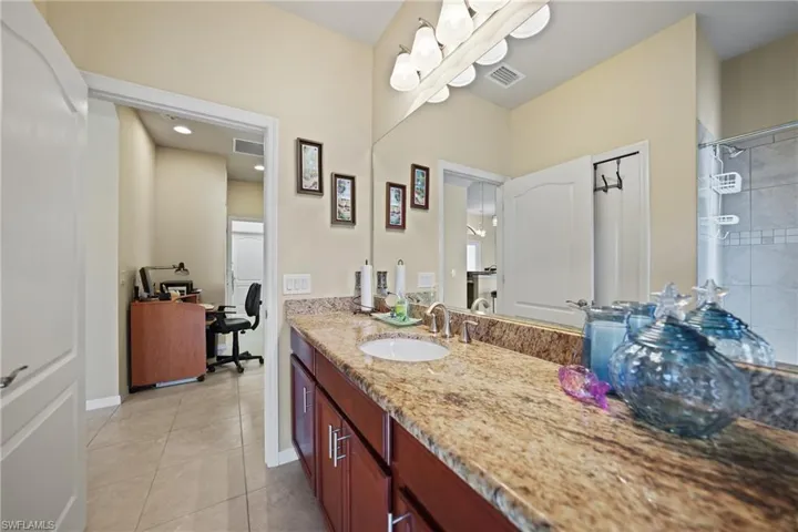 Bathroom with tile patterned flooring and vanity