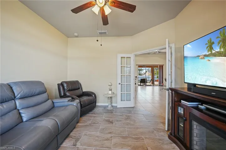 Living room featuring ceiling fan and french doors