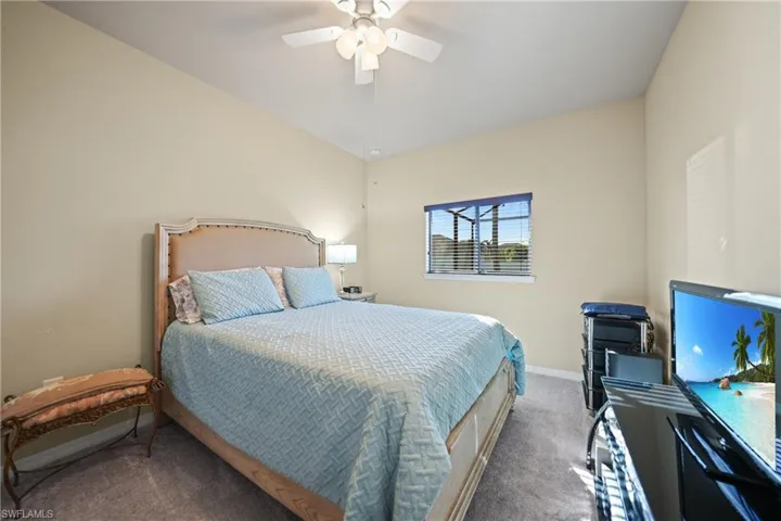 Carpeted bedroom with ceiling fan