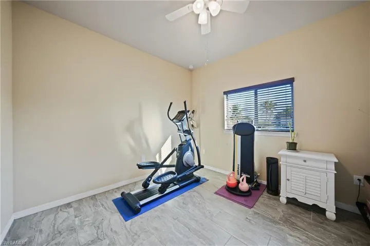 Workout room featuring ceiling fan