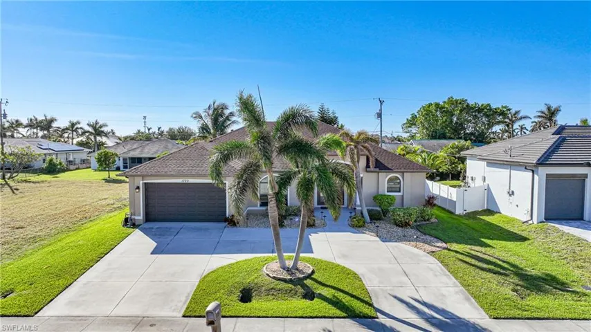 View of front of house with a front lawn and a garage