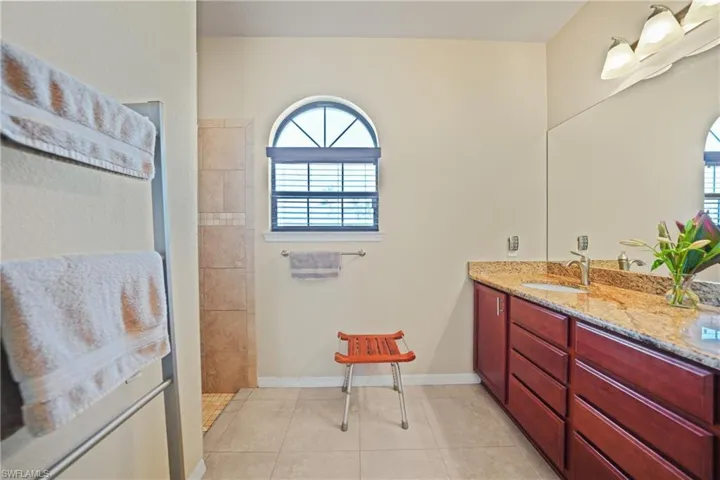 Bathroom featuring tile patterned flooring and vanity