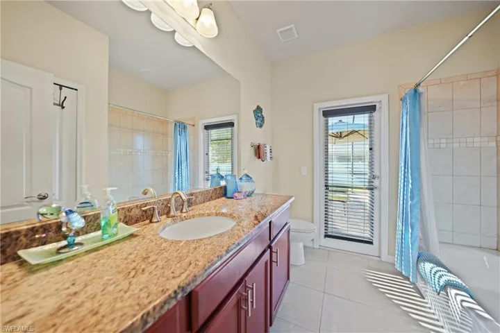 Bathroom featuring tile patterned flooring, vanity, and toilet