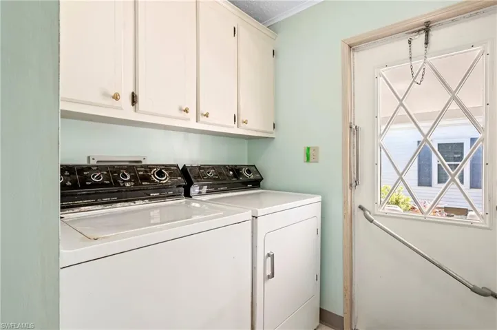 Laundry area with cabinet space and separate washer and dryer