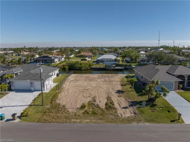 Aerial perspective of suburban area with a nearby body of water