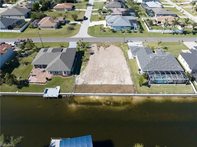Aerial view of property's location with nearby suburban area