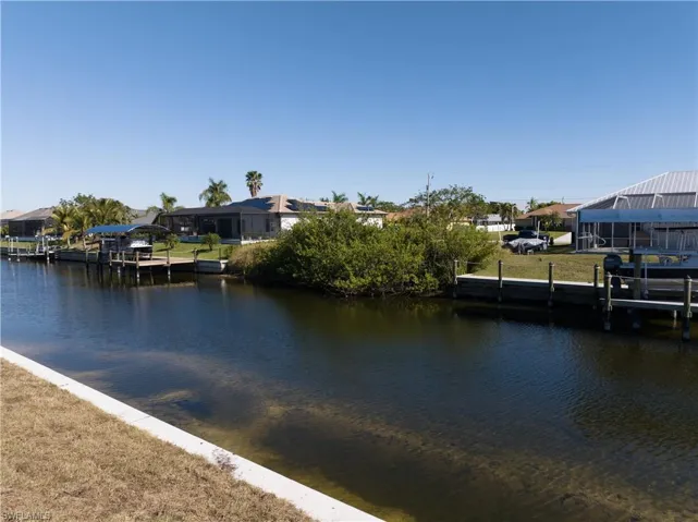 Dock area with a water view and a residential view