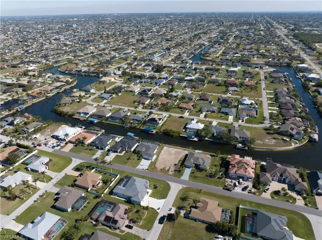 Aerial view of property's location with nearby suburban area